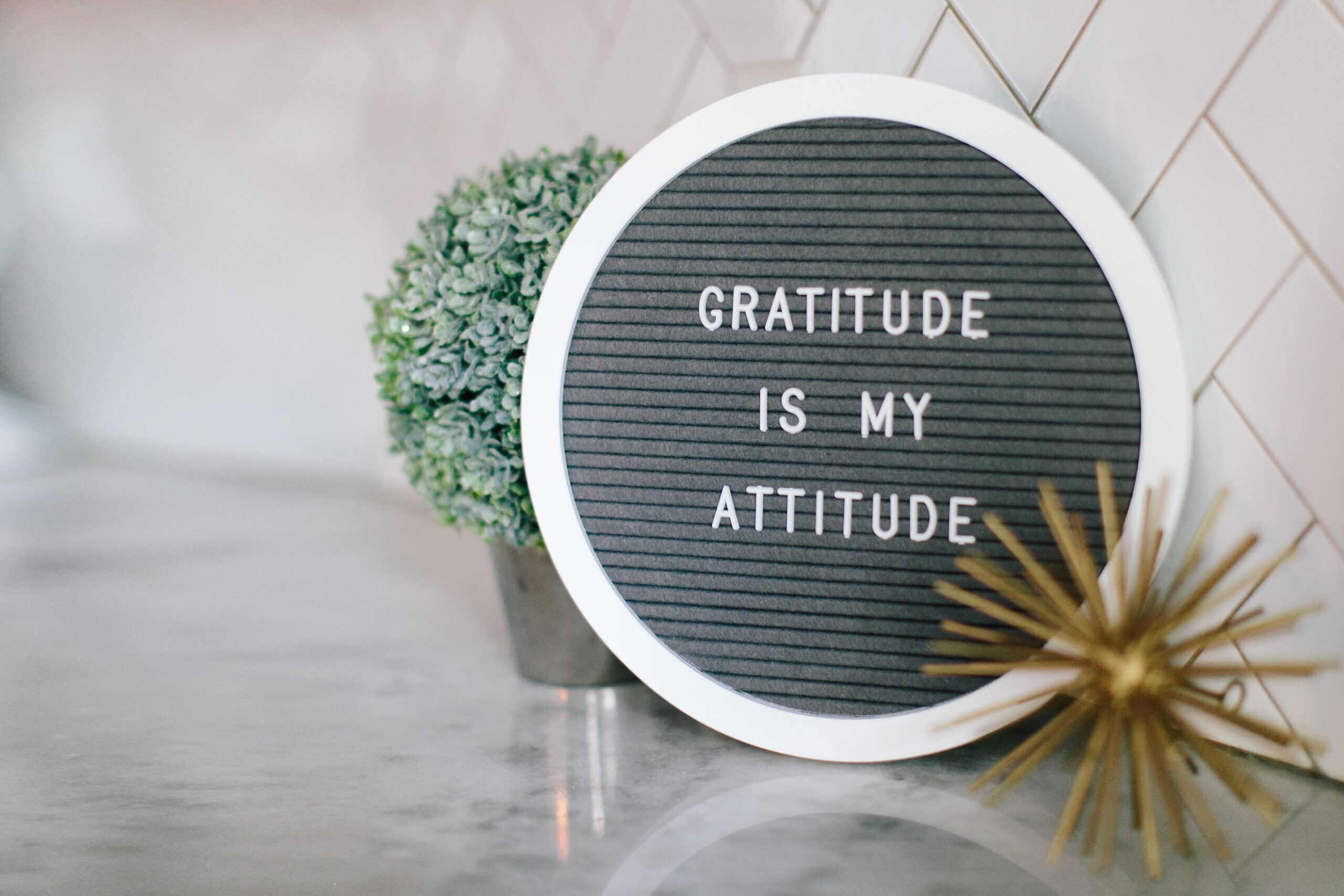 featured sign saying gratitude is my attitude in a boudoir photography studio